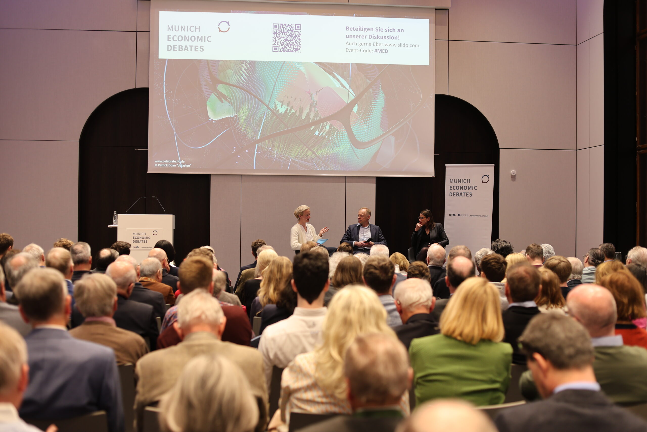 Munich Economic Debates. Auf dem Panel: Lisa Nienhaus, Ressortleiterin Wirtschaft, Süddeutsche Zeitung; Prof. Clemens Fuest, Präsident des Ifo-Instituts für Wirtschaftsforschung; Julia Friedlander, Geschäftsführerin, Atlantik-Brücke.